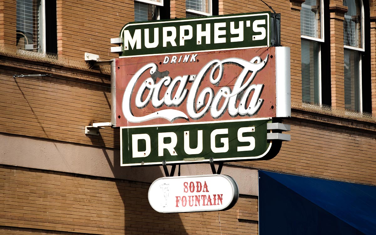 A vintage Murphey’s Drugs sign with a Drink Coca-Cola panel and a Soda Fountain plate