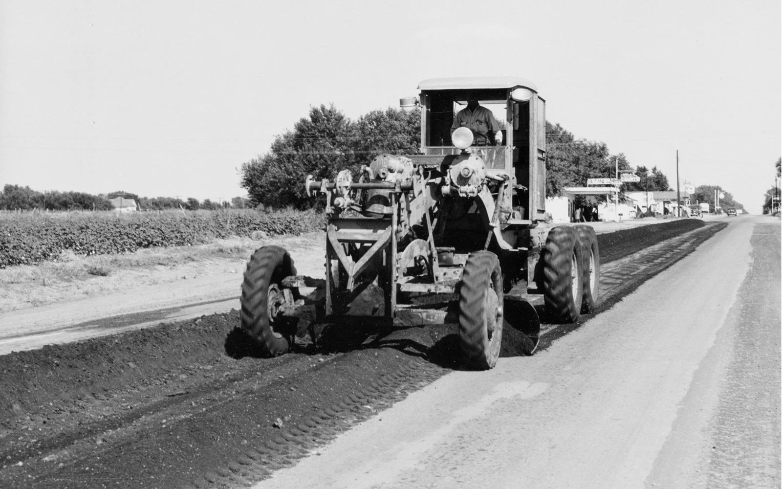 Crews laying oil stabilized asphalt on Route 66